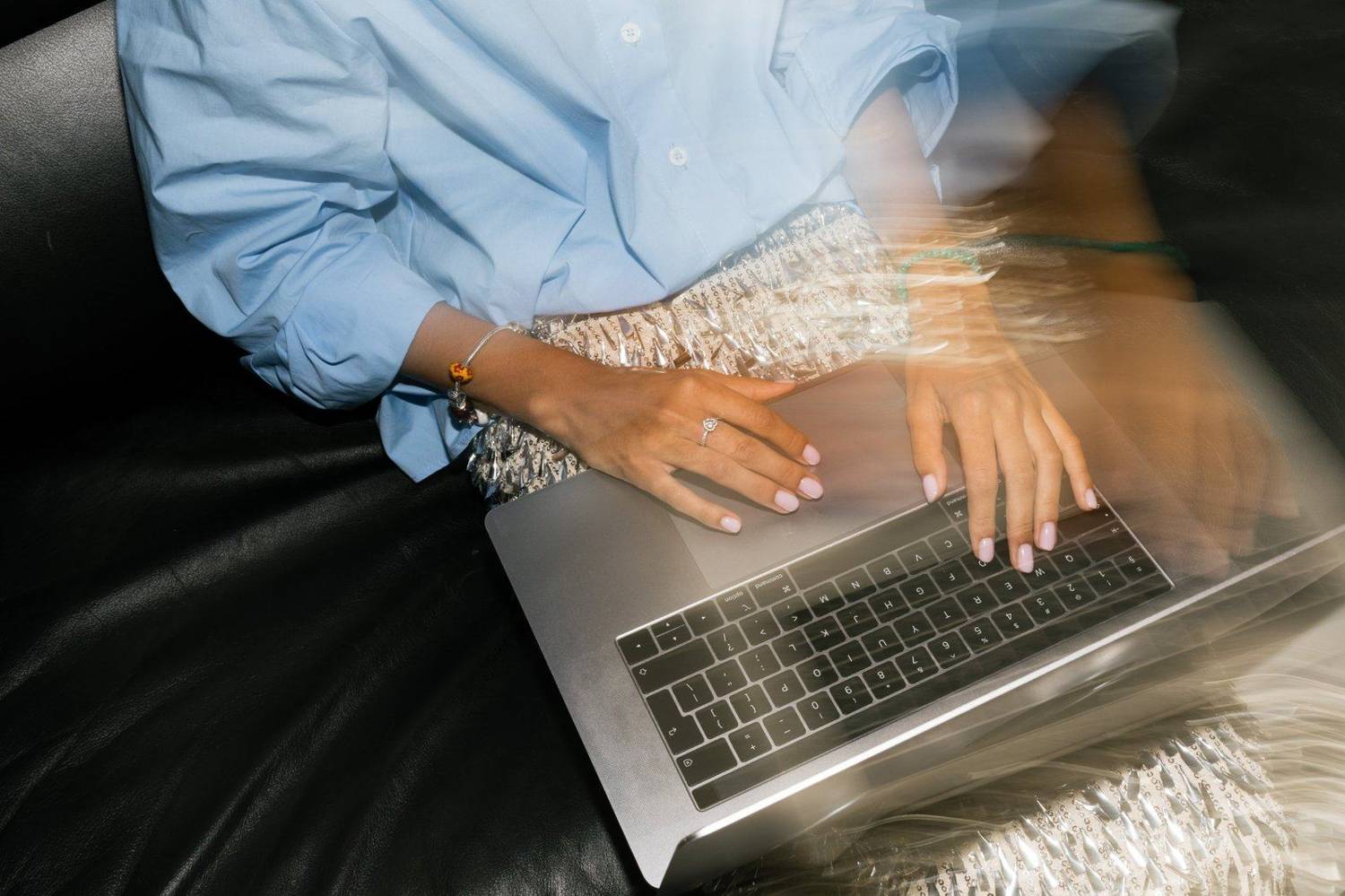 Hands typing on a laptop in motion blur